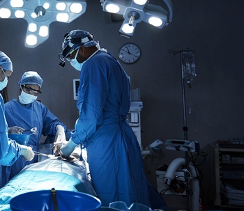 A surgeon performing surgery on a patient